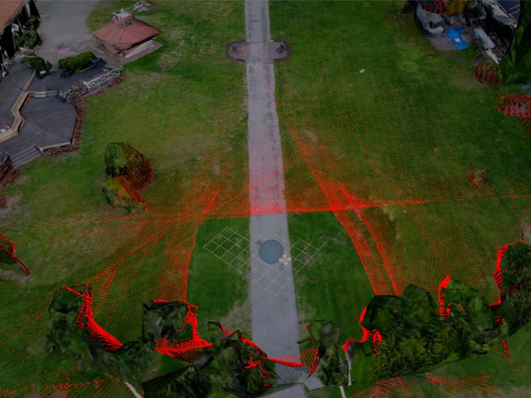 A screenshot from RViz, showing a composite image of red projections on a green lawn