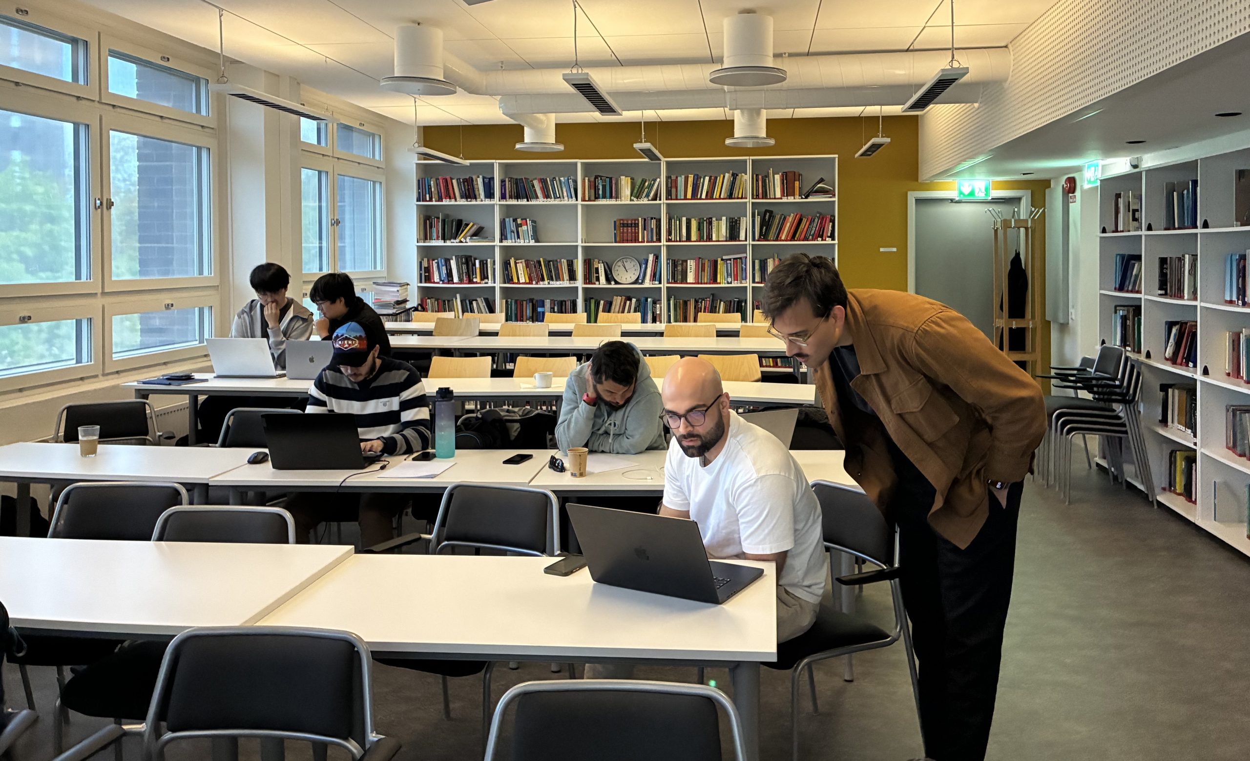 Teacher helping a PhD student in class