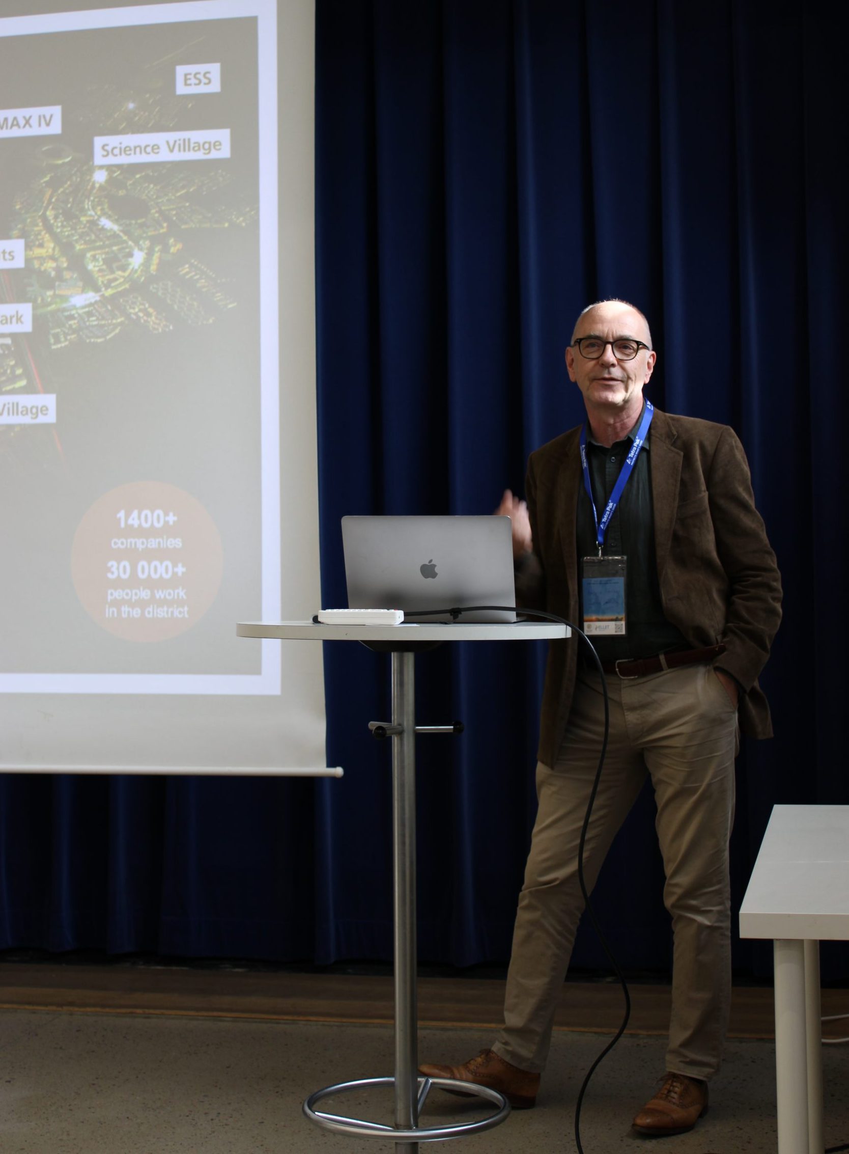 Researcher presenting behind a standing table