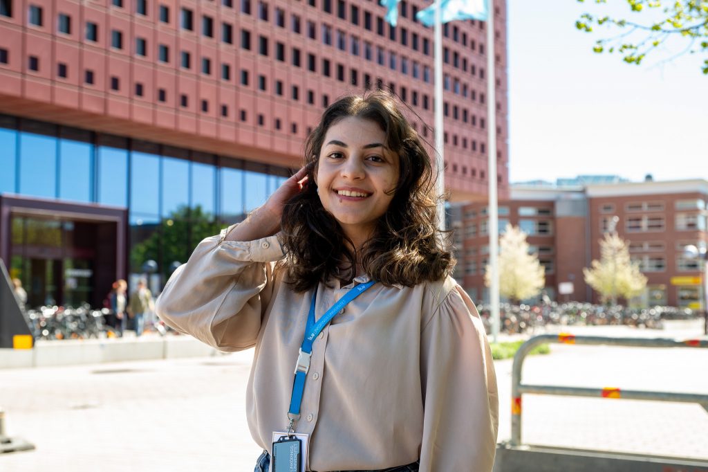Woman in front of campus building.