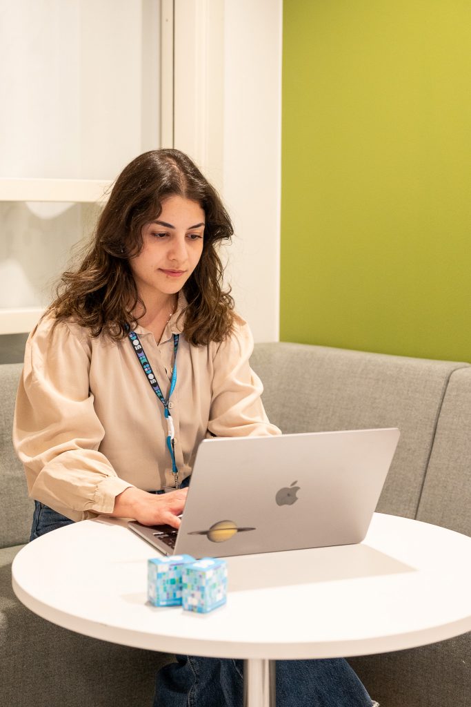 Woman typing on laptop.