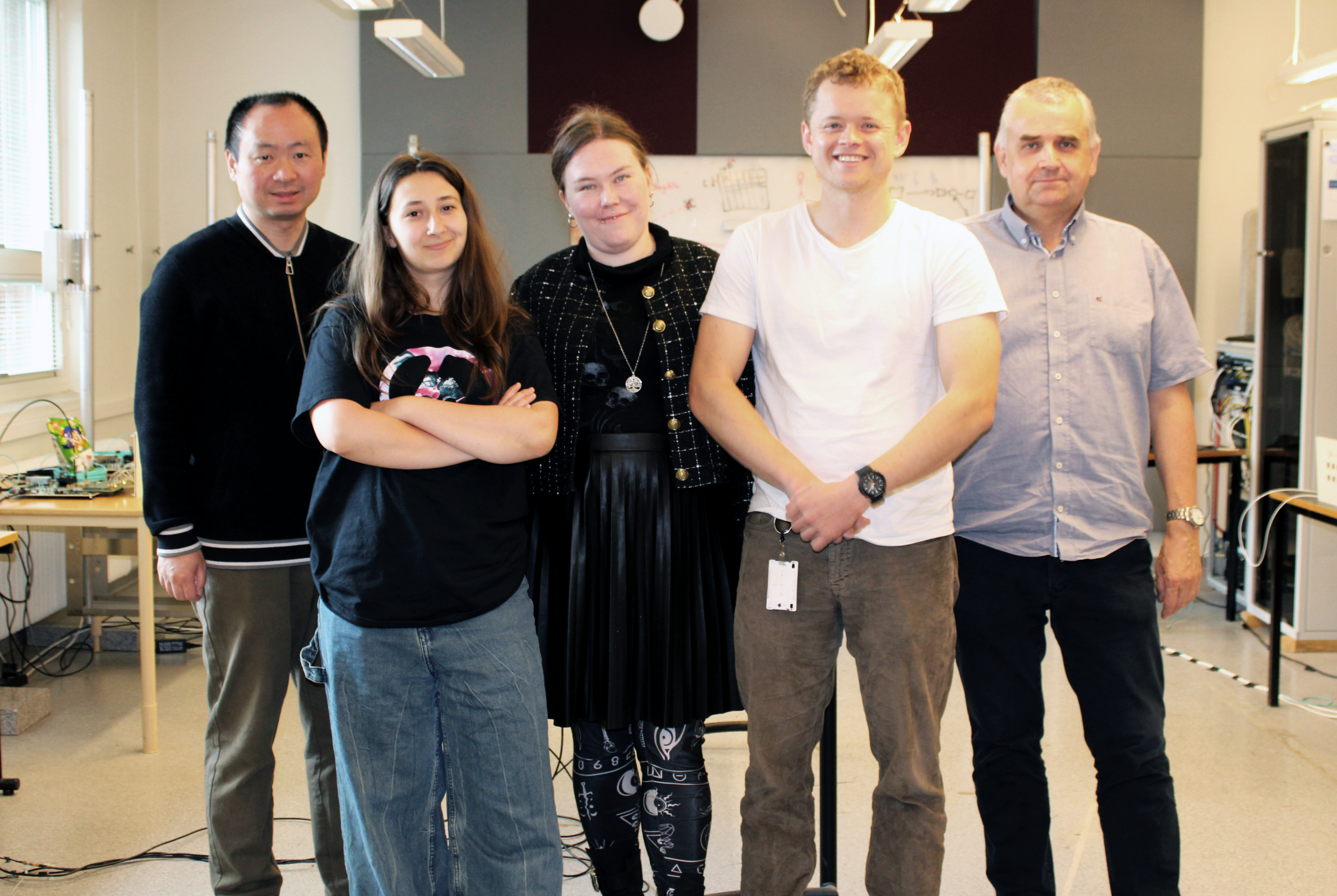 Group photo of researchers in an electronics lab
